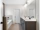 Modern bathroom with double vanity, white countertop, sleek black hardware, and tile flooring for a clean, contemporary design at 712 Shetland Trl, Cartersville, GA 30121