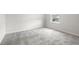 Bright bedroom features plush carpeting, ample natural light through the window, and clean, neutral walls for a serene atmosphere at 712 Shetland Trl, Cartersville, GA 30121