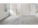 Bright, carpeted bedroom features a large window and two entry doors, offering a spacious and inviting atmosphere at 712 Shetland Trl, Cartersville, GA 30121