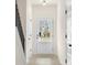 Bright entryway featuring a glass-paneled door, light hardwood floors, and a staircase to the upper level at 712 Shetland Trl, Cartersville, GA 30121