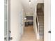 Inviting entryway with view of the kitchen, featuring hardwood floors, and a carpeted staircase to the upper level at 712 Shetland Trl, Cartersville, GA 30121