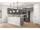 Open concept kitchen with gray cabinets, stainless steel appliances, and a large island at 712 Shetland Trl, Cartersville, GA 30121