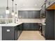 Modern kitchen with gray cabinets, stainless steel appliances, and a large center island at 712 Shetland Trl, Cartersville, GA 30121
