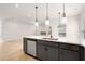 Spacious kitchen with stainless steel dishwasher, large island and modern pendant lighting at 712 Shetland Trl, Cartersville, GA 30121
