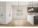 Bright eat-in kitchen featuring stainless steel appliances, gray cabinets, and hardwood floors at 712 Shetland Trl, Cartersville, GA 30121