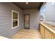 This outdoor patio features wood decking and gray siding with a window and glass door at 712 Shetland Trl, Cartersville, GA 30121