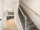 Carpeted staircase with decorative black iron spindles and light wood handrail leading to the upper level at 712 Shetland Trl, Cartersville, GA 30121