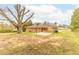 A sprawling lawn defines this backyard, complemented by a concrete patio and classic brick home at 2852 Crabapple Lane, Dacula, GA 30019