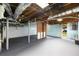Unfinished basement with exposed duct work, gray painted floor, and a door to the backyard at 2852 Crabapple Lane, Dacula, GA 30019