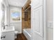Bathroom featuring a sink, toilet, bathtub, and a window for natural light at 2852 Crabapple Lane, Dacula, GA 30019