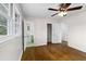 Bedroom with hardwood floors, ceiling fan, a glimpse into a bathroom and a closet at 2852 Crabapple Lane, Dacula, GA 30019