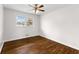 Bedroom with hardwood floors, natural light from the window, and a ceiling fan at 2852 Crabapple Lane, Dacula, GA 30019