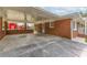 Spacious brick carport offering ample covered parking with a view of the quaint red barn at 2852 Crabapple Lane, Dacula, GA 30019