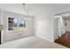 Cozy dining area adjacent to the kitchen featuring tiled flooring and a stylish light fixture at 2852 Crabapple Lane, Dacula, GA 30019
