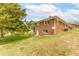 A view of a two-story brick home from the side, showcasing the well-maintained lawn at 2852 Crabapple Lane, Dacula, GA 30019