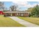 Charming brick home with a carport and landscaped front yard showcasing classic suburban appeal at 2852 Crabapple Lane, Dacula, GA 30019
