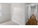 Bright hallway with hardwood floors leading to rooms with neutral walls and white trim at 2852 Crabapple Lane, Dacula, GA 30019