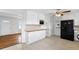 Bright kitchen equipped with sleek black appliances, efficient white cabinetry, and tiled floors at 2852 Crabapple Lane, Dacula, GA 30019