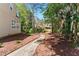 View of a well-manicured backyard and walkway bordered by verdant trees and lush foliage at 4441 Langdon Se Walk, Smyrna, GA 30080