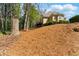 Backyard featuring mature trees, a deck, and a sloped landscape at 4441 Langdon Se Walk, Smyrna, GA 30080