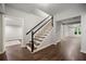 Finished basement featuring an open staircase, hardwood floors, and neutral paint at 4441 Langdon Se Walk, Smyrna, GA 30080
