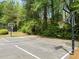 Community basketball court surrounded by trees offers an inviting outdoor recreational space for residents to enjoy some exercise at 4441 Langdon Se Walk, Smyrna, GA 30080