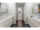 Bright bathroom features dual sinks, white cabinetry, marble countertops, and modern fixtures at 4441 Langdon Se Walk, Smyrna, GA 30080