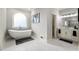 Bright bathroom featuring a modern tub with an arched window and double sink vanity at 4441 Langdon Se Walk, Smyrna, GA 30080
