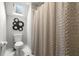 Contemporary bathroom features a white toilet, a skylight, and textured shower curtain at 4441 Langdon Se Walk, Smyrna, GA 30080