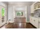 Open breakfast area with hardwood floors and white cabinets next to the door to the deck at 4441 Langdon Se Walk, Smyrna, GA 30080