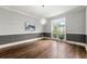 Formal dining room with hardwood floors, stylish lighting fixture, and large window offering a serene view at 4441 Langdon Se Walk, Smyrna, GA 30080