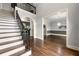 Inviting foyer with staircase, hardwood floors, and elegant arched doorway offering a glimpse into the home at 4441 Langdon Se Walk, Smyrna, GA 30080