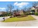 Beautiful home exterior with landscaped front yard, lush lawn and inviting driveway on a sunny day at 4441 Langdon Se Walk, Smyrna, GA 30080