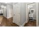 Hallway with hardwood floors featuring a view of a well-appointed bathroom at 4441 Langdon Se Walk, Smyrna, GA 30080