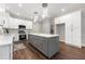 Beautiful kitchen with gray island, stainless steel appliances, hardwood floors, and pendant lights at 4441 Langdon Se Walk, Smyrna, GA 30080