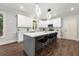 Bright kitchen with a large island, modern lighting, white cabinets, and stainless steel appliances at 4441 Langdon Se Walk, Smyrna, GA 30080