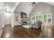 Open living room with hardwood floors, fireplace, built-in shelving and many windows at 4441 Langdon Se Walk, Smyrna, GA 30080