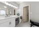 Main bathroom with double sinks, vanity, and an entrance to a walk-in closet at 4441 Langdon Se Walk, Smyrna, GA 30080