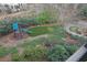 Aerial view of backyard featuring a playset, putting green, and manicured landscaping at 1025 Abingdon Ln, Johns Creek, GA 30022