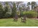 Beautiful backyard with green grass and a relaxing outdoor seating area at 1025 Abingdon Ln, Johns Creek, GA 30022