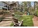 Serene backyard featuring lush green grass, mature trees, and a playset at 1025 Abingdon Ln, Johns Creek, GA 30022