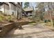 Flagstone patio view of the backyard with a stone retaining wall and play area at 1025 Abingdon Ln, Johns Creek, GA 30022