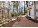 Professionally landscaped backyard with mature trees, lush plantings, and a brick pathway at 1025 Abingdon Ln, Johns Creek, GA 30022