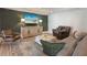 Cozy seating area in finished basement featuring a leather recliner and a plush sofa with green pillows at 1025 Abingdon Ln, Johns Creek, GA 30022