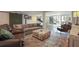 Open basement design with a large leather couch, decorative rug, and built-in basketball hoop game at 1025 Abingdon Ln, Johns Creek, GA 30022