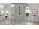 Modern bathroom showcasing a frameless glass shower, white cabinets, and contemporary fixtures, providing a luxurious spa-like experience at 1025 Abingdon Ln, Johns Creek, GA 30022