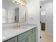 Bathroom featuring a vanity with marble countertop, a gold faucet, and a modern light fixture at 1025 Abingdon Ln, Johns Creek, GA 30022