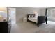 Bright bedroom with neutral paint, carpet, and a doorway that leads to another room at 1025 Abingdon Ln, Johns Creek, GA 30022