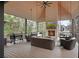 A cozy covered patio complete with an outdoor fireplace, TV, ceiling fan and comfortable furniture at 1025 Abingdon Ln, Johns Creek, GA 30022