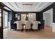Sophisticated dining room with dark blue walls, wainscoting, coffered ceiling, and modern light fixture at 1025 Abingdon Ln, Johns Creek, GA 30022